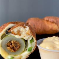 Taco Dill Dough · Cored Dill pickle stuffed with spicy Chorizo and creamy Chihuahua cheese. Rolled in a Jalape...