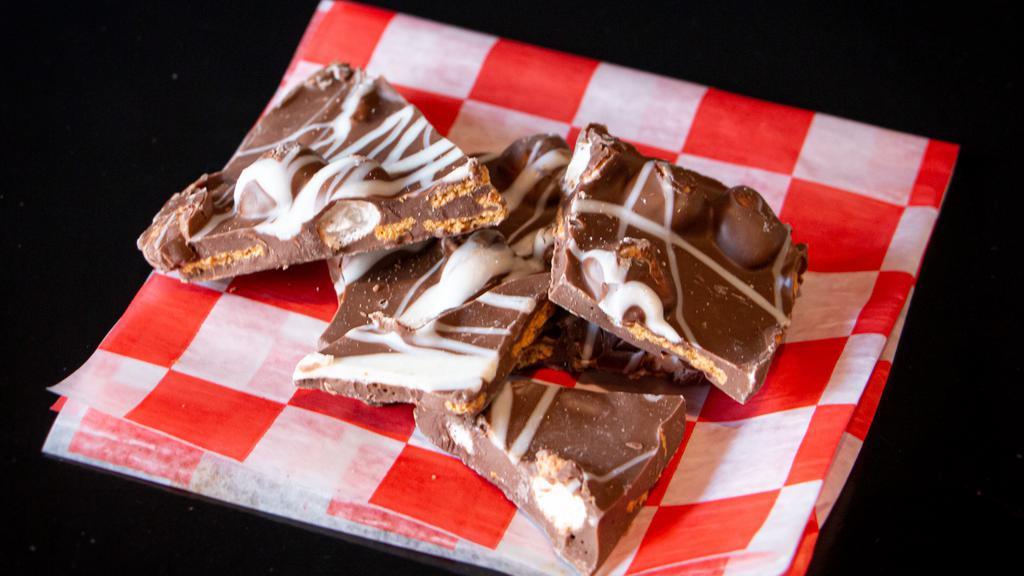 S’Mores Bark · Rich Milk Chocolate set and broken into pieces with Mini Marshmallow and Graham Cracker Crumble for that campfire feel.
