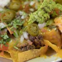Loaded Nachos · Chips with a layer of beans and a choice of chicken or ground beef, melted cheese, lettuce, ...