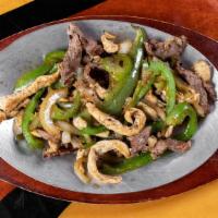 Fajitas · A sizzling plate of grilled sliced steak with sautéed green peppers and onions. Served with ...