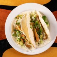 Fish Tacos Dinner · Two corn tortillas filled with grilled tilapia, onions and cilantro. Served with a side of g...