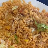 Arroz Con Pollo · Mexican rice topped with shredded chicken and melted cheese.