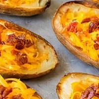 Potato Skins · With bacon, Cheddar cheese and sour cream.