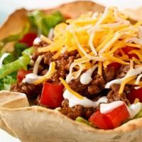 Taco Salad · Crisp lettuce, tomato, onions, black olives, loose ground beef and Cheddar cheese.