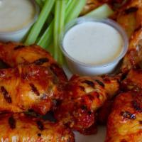 Jumbo Bone In Chicken Wings · 8 bone-in chicken wings, breaded or naked.  Your choice of 2 sauces and either blue cheese o...