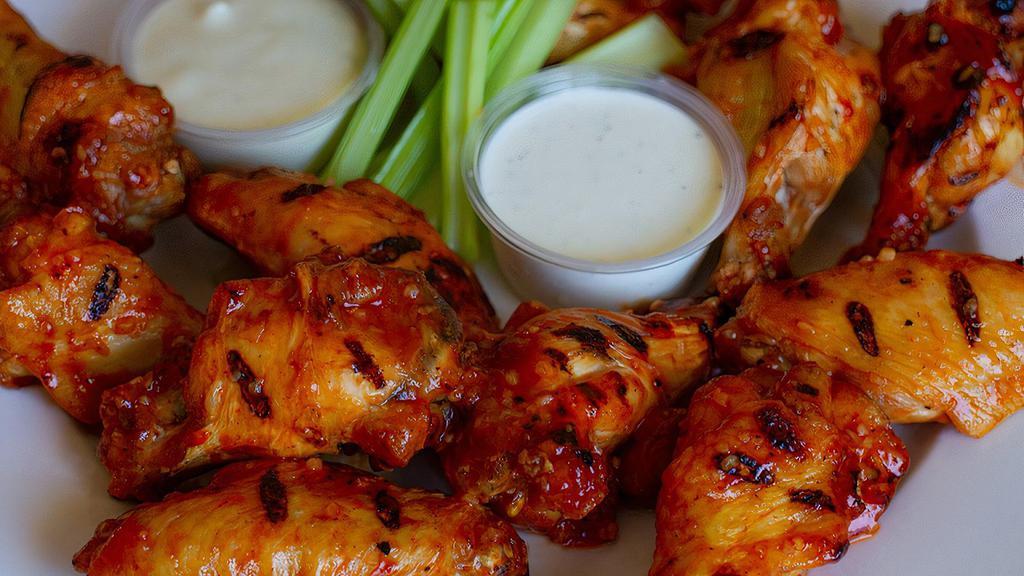 Jumbo Bone In Chicken Wings · 8 bone-in chicken wings, breaded or naked.  Your choice of 2 sauces and either blue cheese or ranch. Served with celery.