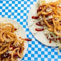 Bbq Taco · Pulled chicken, shredded white queso, coleslaw, bbq sauce, crispy onion straws.