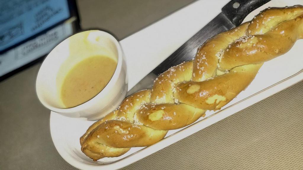 Pretzel & Beer Cheese Fondue · Vegetarian. Creamy blend of cheddar cheese, smoked onions, spices and chatterbox speakeasy lager. Served with a salt crusted warm pretzel for dipping.