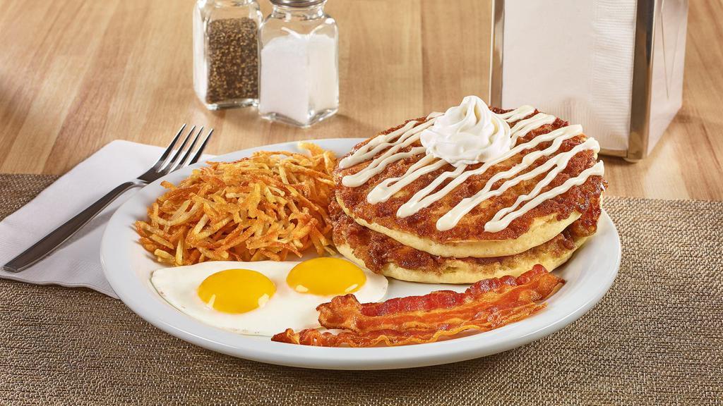 Cinnamon Roll Pancake Breakfast · Buttermilk pancakes cooked with cinnamon crumb topping and topped with whipped cream and cream cheese icing. Served with eggs,* hash browns, plus bacon strips or sausage links. .