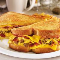 The Grand Slamwich®. · Scrambled eggs, sausage, bacon, ham and American cheese on potato bread grilled with a maple...