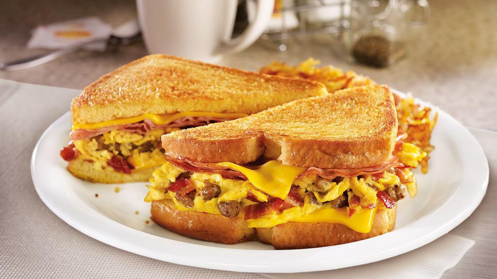 The Grand Slamwich®. · Scrambled eggs, sausage, bacon, ham and American cheese on potato bread grilled with a maple spice spread. Served with hash browns.