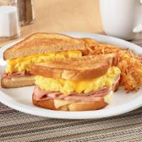 Moons Over My Hammy®. · Ham and scrambled egg sandwich with Swiss & American cheeses on grilled sourdough. Served wi...