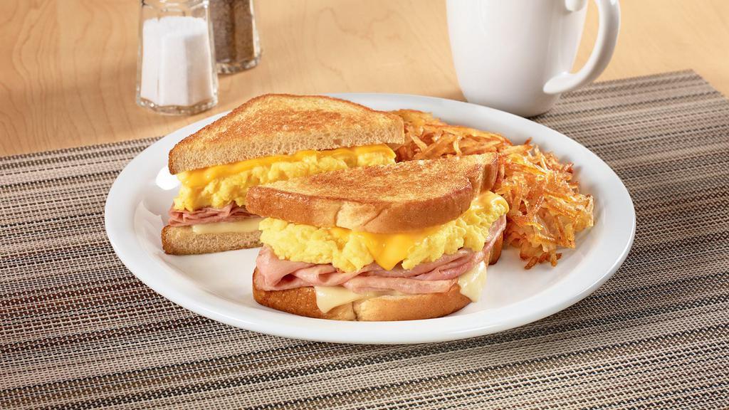 Moons Over My Hammy®. · Ham and scrambled egg sandwich with Swiss & American cheeses on grilled sourdough. Served with hash browns.