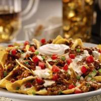 Zesty Nachos. · Tortilla chips cooked fresh to order. Served with Pepper Jack queso, shredded Cheddar cheese...