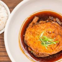 Egg Foo Young · Egg patty with vegetables smothered with brown sauce.