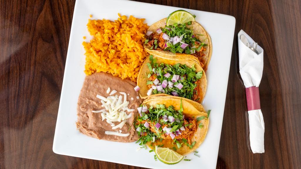Taco Dinner Plate · Your choice of meat, refried beans, lettuce, tomato, mayo, onions, sour cream, queso fresco, choice of meat served with Mexican rice, and beans.