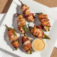 Torito Poppers · Bacon wrapped jalapeños stuffed with cream cheese and dried cranberry