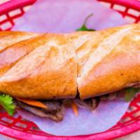 Bánh Mì Thịt Nướng · Crispy baguette stuffed with marinated grilled pork, cucumber, pickled daikon & carrots, cil...