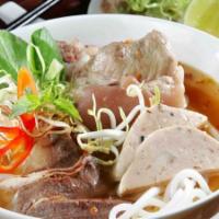 Bún Bò Huế · Thick rice noodle spicy soup with tender beef, pork hock, and sliced pork roll.
