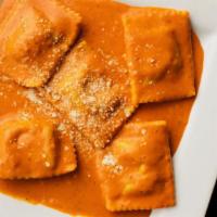 Ravioli Maria Rosa · Ravioli stuffed with ricotta cheese and spinach. Cooked and served with tomato cream sauce.