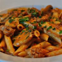 Penne Norcia · Penne pasta cooked with mild Italian sausage, mushrooms, garlic and tomato cream sauce.