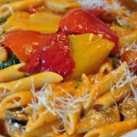 Penne Ortolana · Penne pasta with Portobello mushrooms, onions, spinach, red peppers, asparagus and tomato cr...