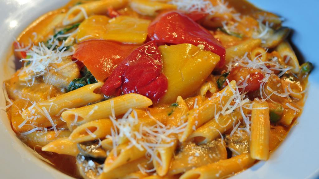 Penne Ortolana · Penne pasta with Portobello mushrooms, onions, spinach, red peppers, asparagus and tomato cream sauce.