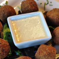 Olive All’Ascolana · Breaded green olives stuffed with ground veal and fried. Served with white cream sauce.