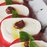 Caprese · Fresh buffalo mozzarella cheese, basil and tomatoes drizzled with oil. Served with a home-ma...