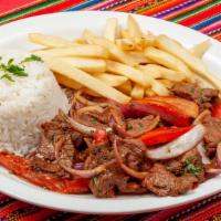 Lomo Saltado · Beef stir-fried with onions, garlic, tomatoes, cilantro, white  wine and soy sauce. Served w...