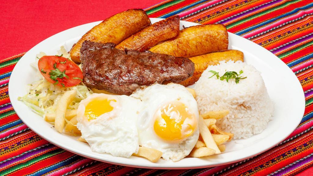 Bistec A Lo Pobre · 7 oz grilled beef tenderloin.  Served with fries, fried plantains, fries eggs, rice and salad.
