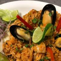 Arroz Con Mariscos · Rice cooked in aji amarilla and panca sauce with shrimp, mussels, calamari, squid, lime, cil...