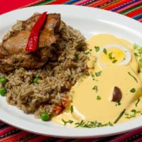 Arroz Con Pollo Y Papa A La Huancaina · Chicken, green rice made with cilantro, garlic and Peruvian yellow pepper, garnished with pe...