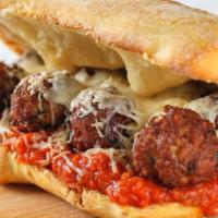 Meatball Sub · Homemade meatballs topped with provolone, marinara sauce, and parmesan cheese, served on Ita...
