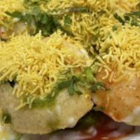 Dahi Puri · Puffy crisps filled with potatoes, chickpeas, yogurt, and chutneys garnished with cilantro