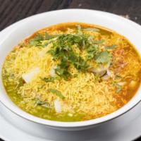 Samosa Chat · Smashed samosa topped with spiced chickpeas, diced onions, yogurt, cilantro and tamarind chu...