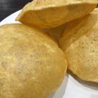 Chole Puri · Masala chickpeas with 3 puri (Fried Bread) served with halwa, pickle, sweet yogurt, and onio...