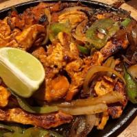 Lunch Fajitas · Grilled chicken or steak, cooked with tomatoes + onions + bell peppers. Served with rice, be...