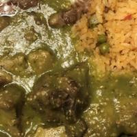Chile Verde · Very tasty sautéed pork tips topped with tomatillo green sauce. Served with beans, rice + to...