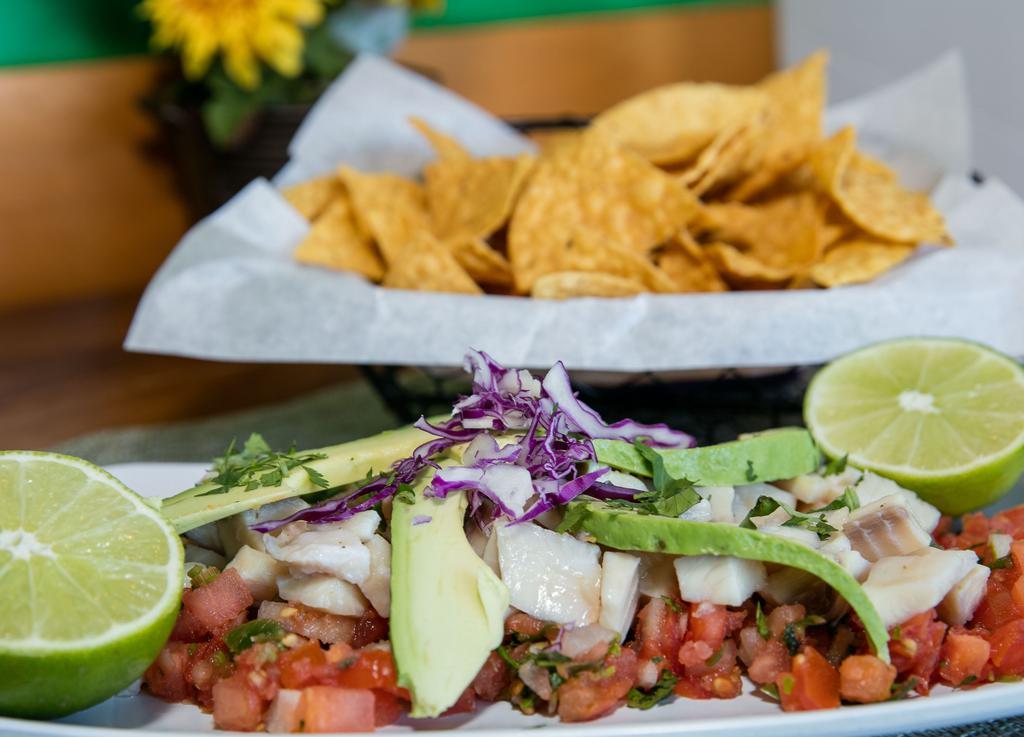Ceviche · Fresh tilapia cured and marinated in lime juice. Served with pico de gallo, avocado. Served with tortillla chips.