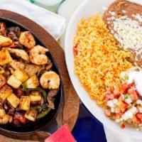 Fajitas Texanas · Shrimp, chicken and steak grilled with tomatoes, onions, bell peppers, and pineapple. Served...
