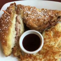 Monte Cristo · Grilled ham, turkey, melted Swiss cheese layered between two slices of challah bread, dipped...