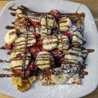 Nutella Crepes · Stuffed with Nutella and bananas and topped with freshly cut strawberries, bananas, and nute...
