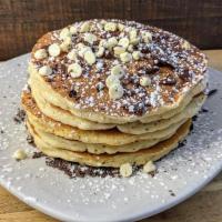 Chocolate Chip Pancakes · Five pancakes with chocolate chips baked inside, topped with white chocolate chips and dark ...
