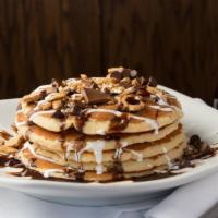 S'Mores Pancakes · Five pancakes filled with chocolate chips, layered with marshmallow creme and topped with gr...