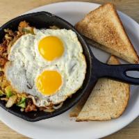 New Mexico Skillet · Chorizo, onion, green pepper, tomatoes, and avocado served over hash browns. Topped with Jac...