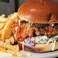 Nashville Chicken Sandwich · Crispy battered chicken breast with coleslaw, house-made pickles, creamy ranch dressing, and...