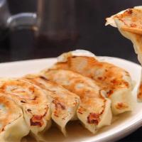 Fried Chinese Pot Stickers 北平锅贴 · Filled with a savory pork and vegetable filling and served with ginger soy sauce.
