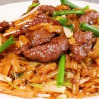 Stir-Fried Rice Noodles With Beef 干炒牛河 · Tender beef slices stir-fried with bean sprouts, scallions, onions, and thick rice noodle in...