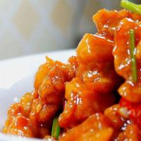 Orange Chicken 橙皮鸡 · Lightly battered chunks of chicken sautéed with dry red pepper in a spicy orange flavored sa...